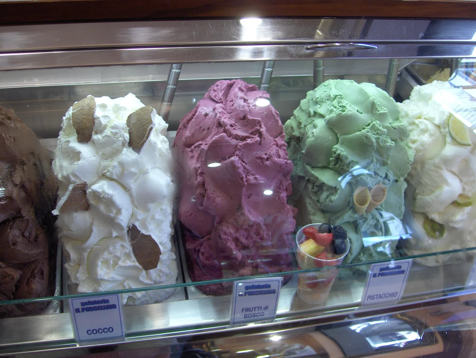 Coconut, fruit and pistachio gelato in a Florence display counter